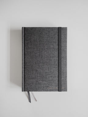 Slate gray textured A5 hardcover diary bound with a matching ribbon and accented by a subtle vertical design stripe, ideal for five years of writing.