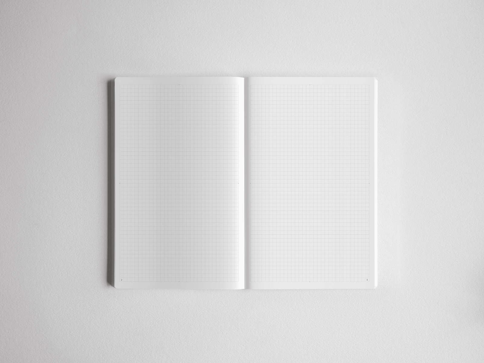 Open, minimalist A5 grid notebook showing light graph paper lines across crisp white pages, perfect for detailed planning, drafting, or note-taking.