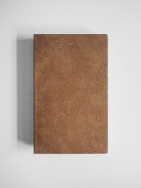 Matte A5 notebook cover featuring a smooth, uniform, cognac-brown leather-textured finish.