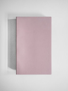 Solid, dusty rose A5 slim grid notebook featuring a minimalist, smooth cover ideal for journaling or academic note-taking.