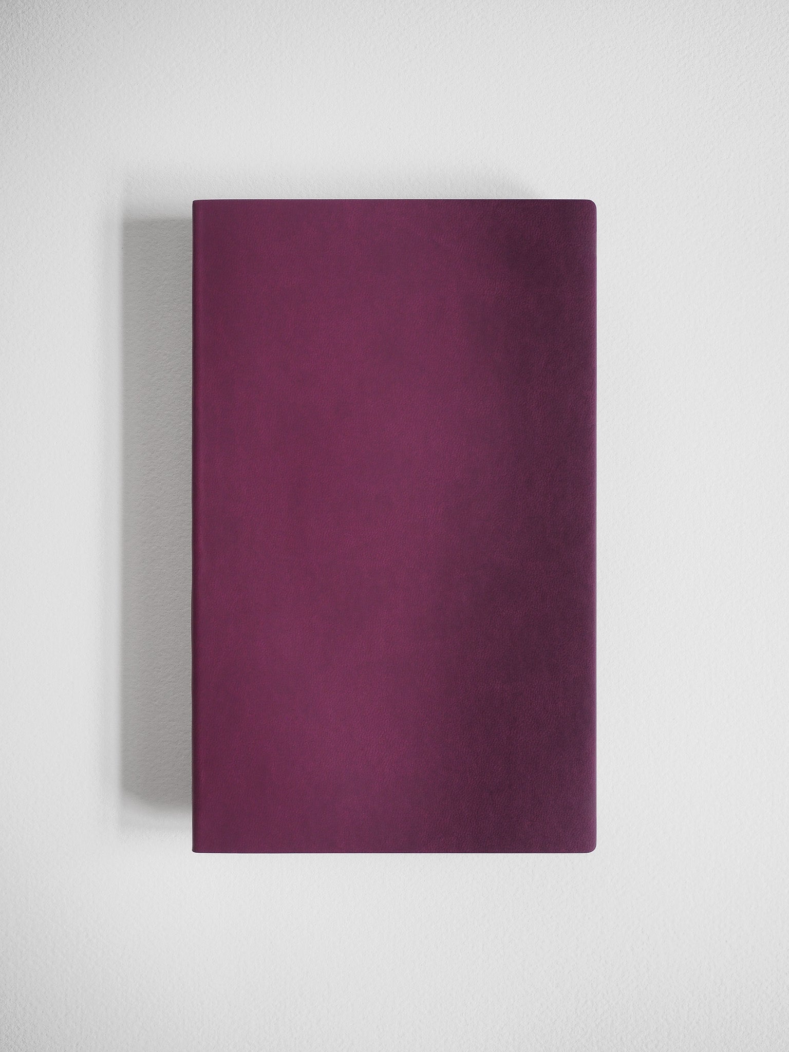 Solid deep magenta A5 notebook featuring a smooth, minimalist cover with no visible patterns or text.