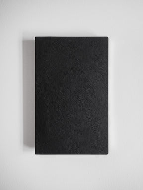Sleek A5 notebook featuring a solid black, subtly textured cover, ideal for journaling or study notes.