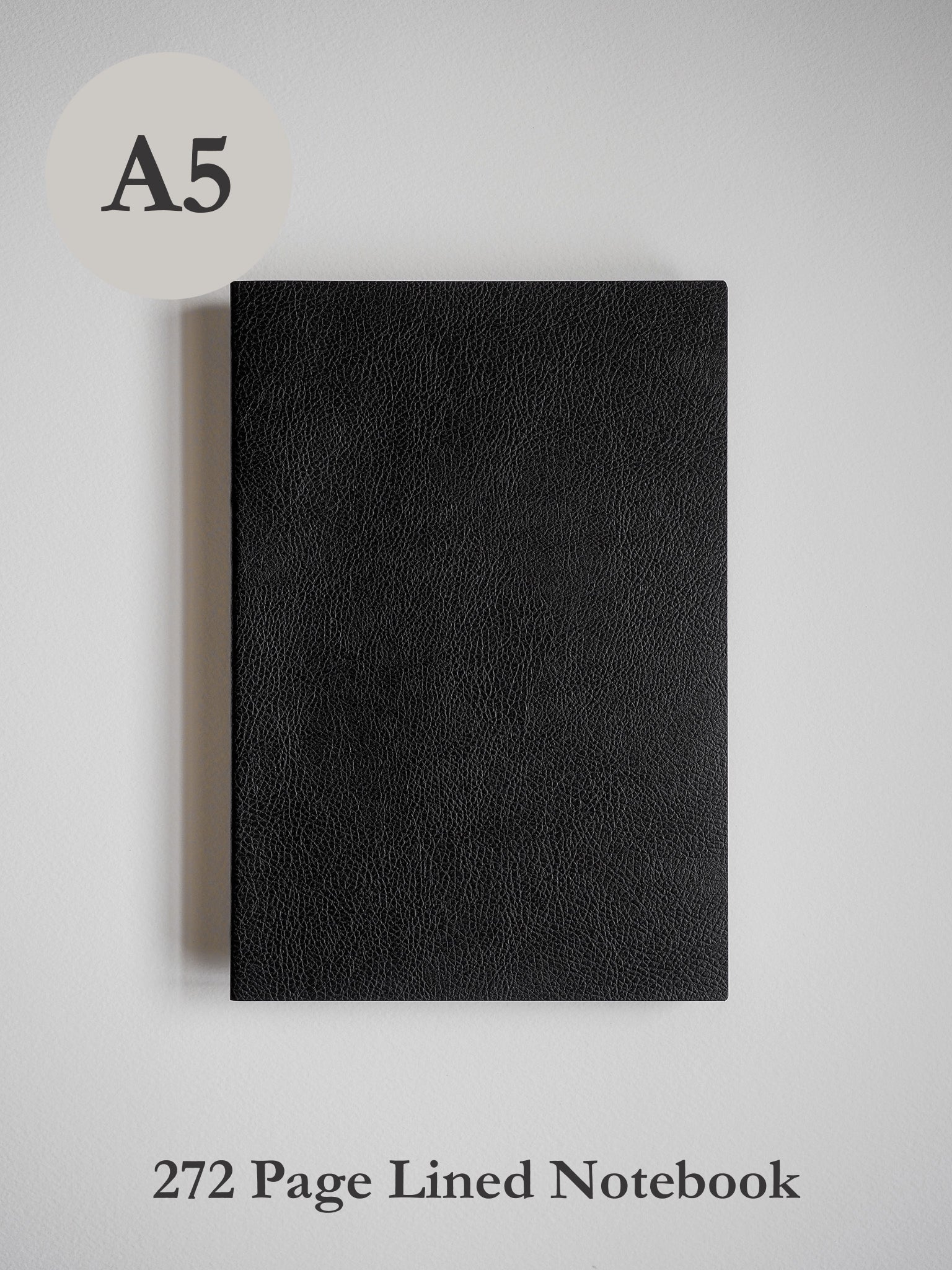 Solid black A5 notebook featuring a rich, textured faux leather cover, designed for journaling or academic writing.