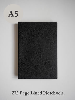 Solid black A5 notebook featuring a rich, textured faux leather cover, designed for journaling or academic writing.