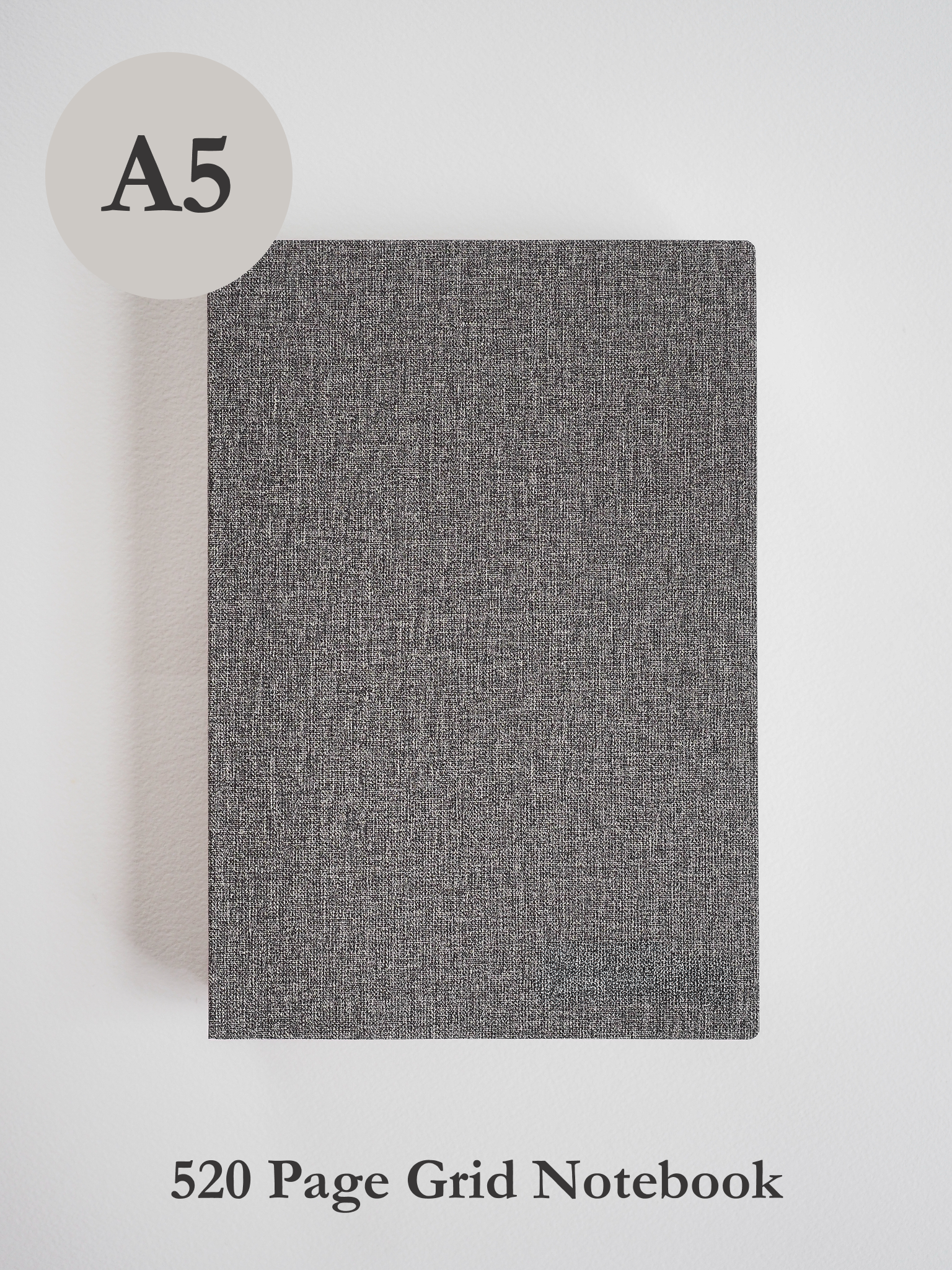 Minimalist A5 grid notebook with a dark charcoal gray, textured linen-like cover, ideal for detailed journaling and writing tasks.