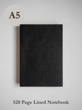 A sleek A5 notebook with a deep black, textured faux leather cover, perfect for writing and journaling across 520 lined pages.