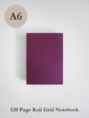 A solid, deep mauve A6 notebook cover, featuring a minimalist design ideal for journaling or structured writing.