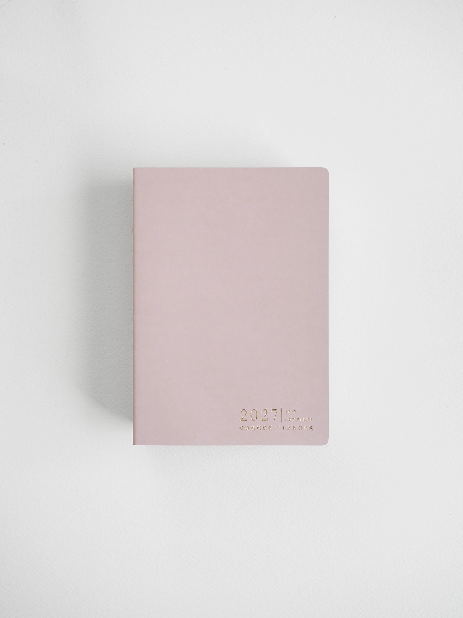A dusty pink 2027 daily planner with gold foil text at the bottom right corner, photographed on a clean white background with a soft shadow.
#Color_Fairyfloss