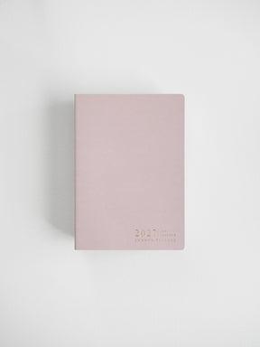 A dusty pink 2027 daily planner with gold foil text at the bottom right corner, photographed on a clean white background with a soft shadow.
#Color_Fairyfloss
