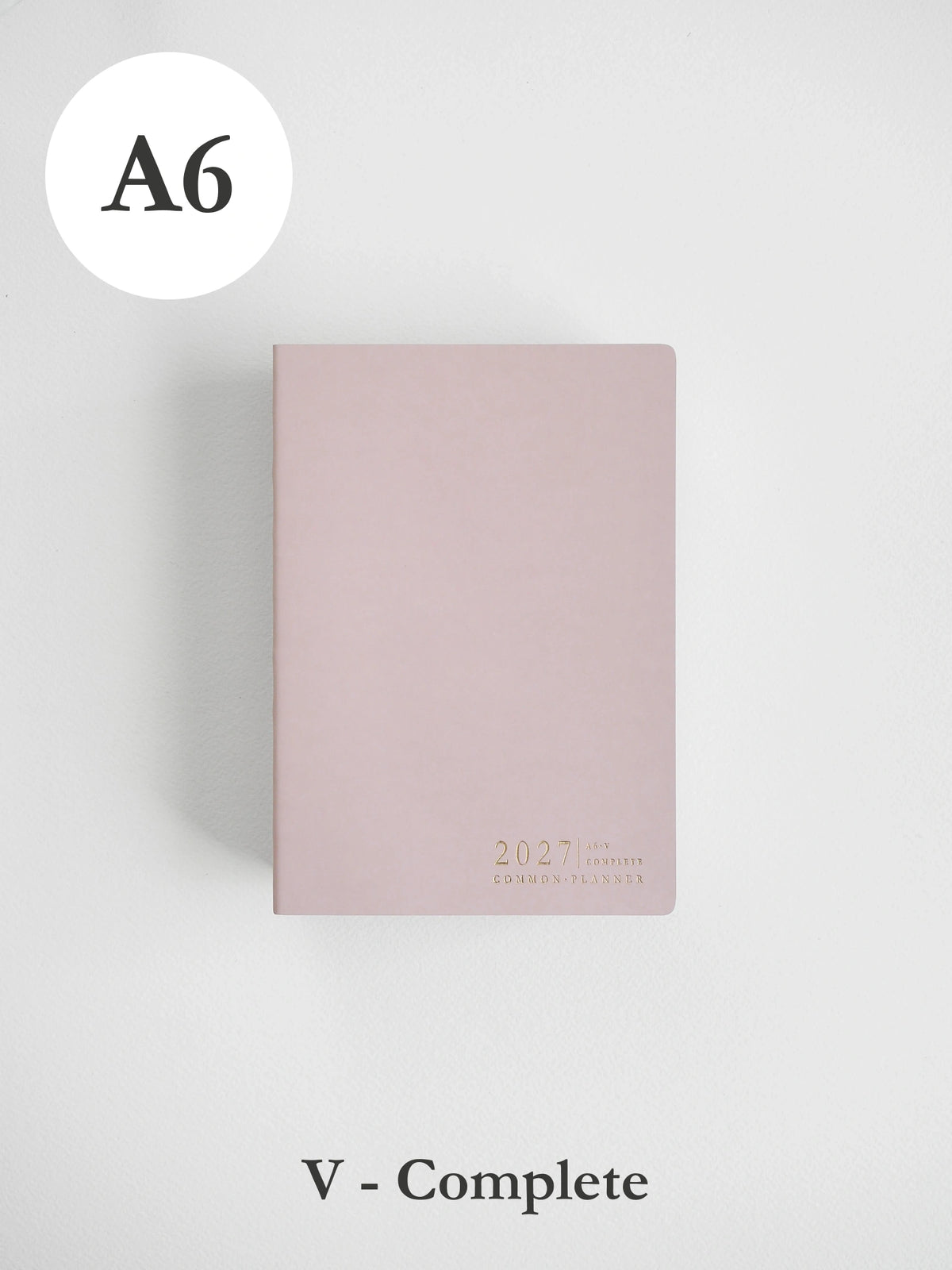 A6 size 2027 daily planner in a dusty pink color, shown closed on a light gray background with 'A6' label in the top left and 'V - Complete' label at the bottom.
#Color_Fairyfloss