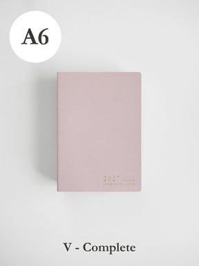 A6 size 2027 daily planner in a dusty pink color, shown closed on a light gray background with 'A6' label in the top left and 'V - Complete' label at the bottom.
#Color_Fairyfloss