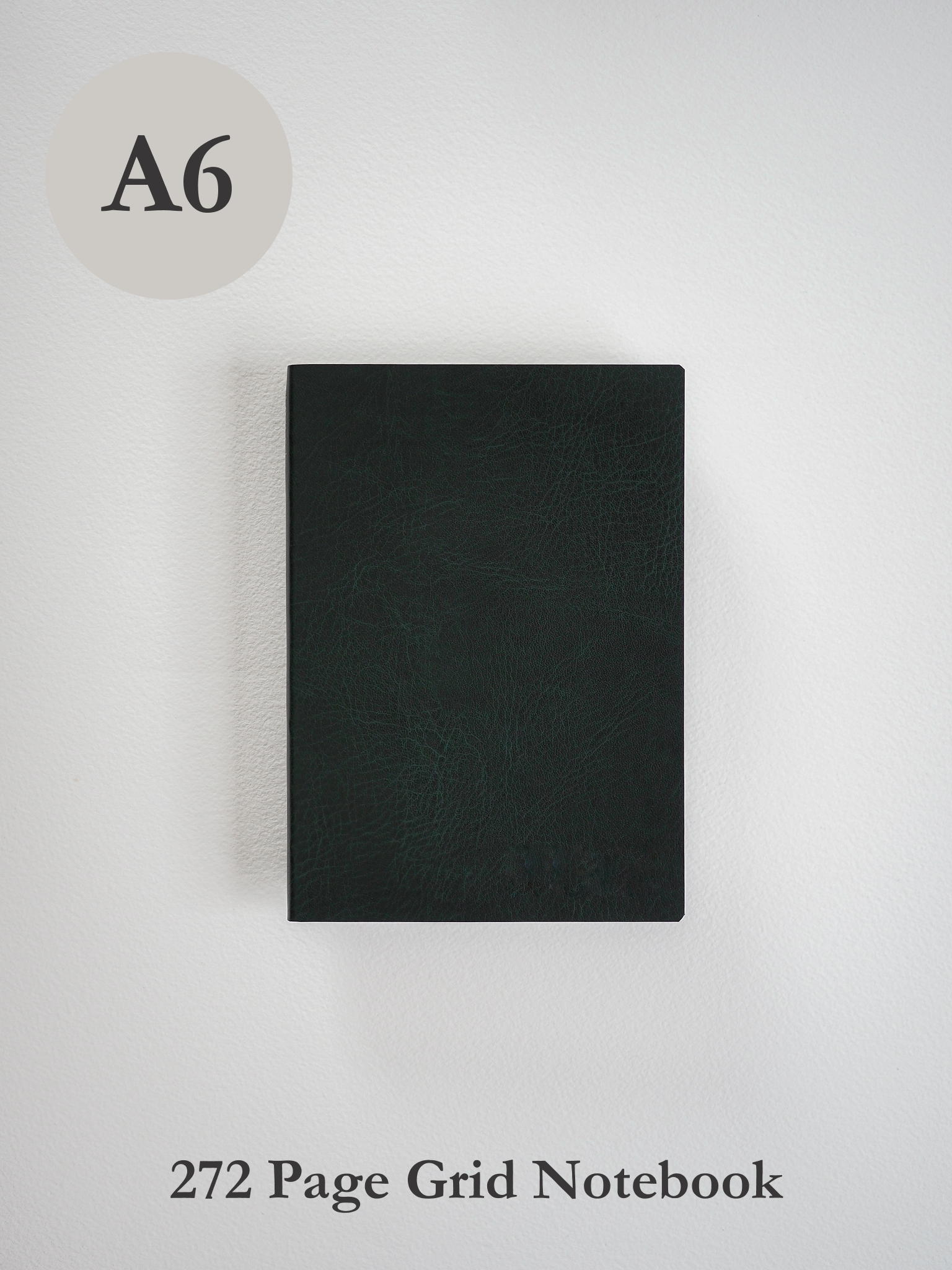 Solid black A6 grid notebook featuring a durable, smooth matte faux leather cover, perfect for minimalist writing and planning.