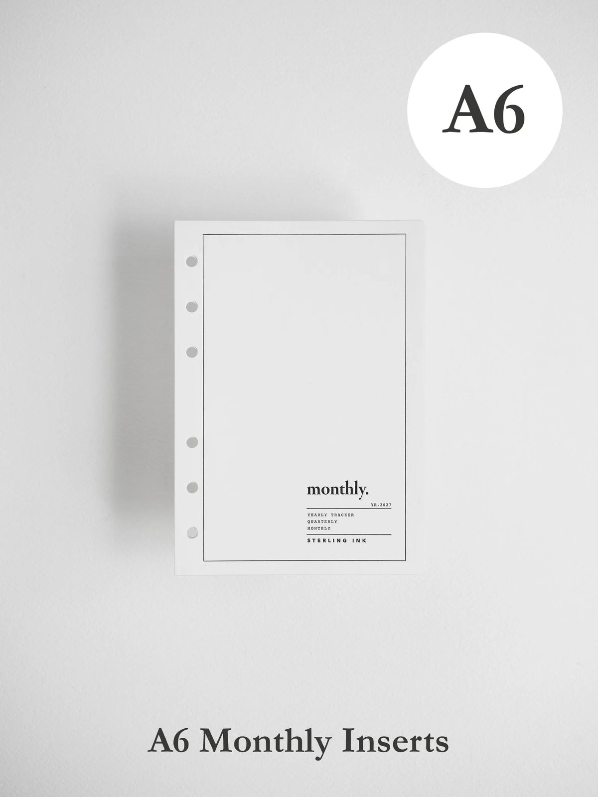 A single A6 monthly planner insert from Sterling Ink, shown against a light gray background with 'A6' in a white circle at the top right and 'A6 Monthly Inserts' text at the bottom.
#Size_A6