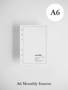 A single A6 monthly planner insert from Sterling Ink, shown against a light gray background with 'A6' in a white circle at the top right and 'A6 Monthly Inserts' text at the bottom.
#Size_A6