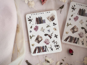Mini sticker sheet of botanical and rustic elements featuring pressed roses, assorted leaves, and stacked vintage rectangular blocks in earthy tones.