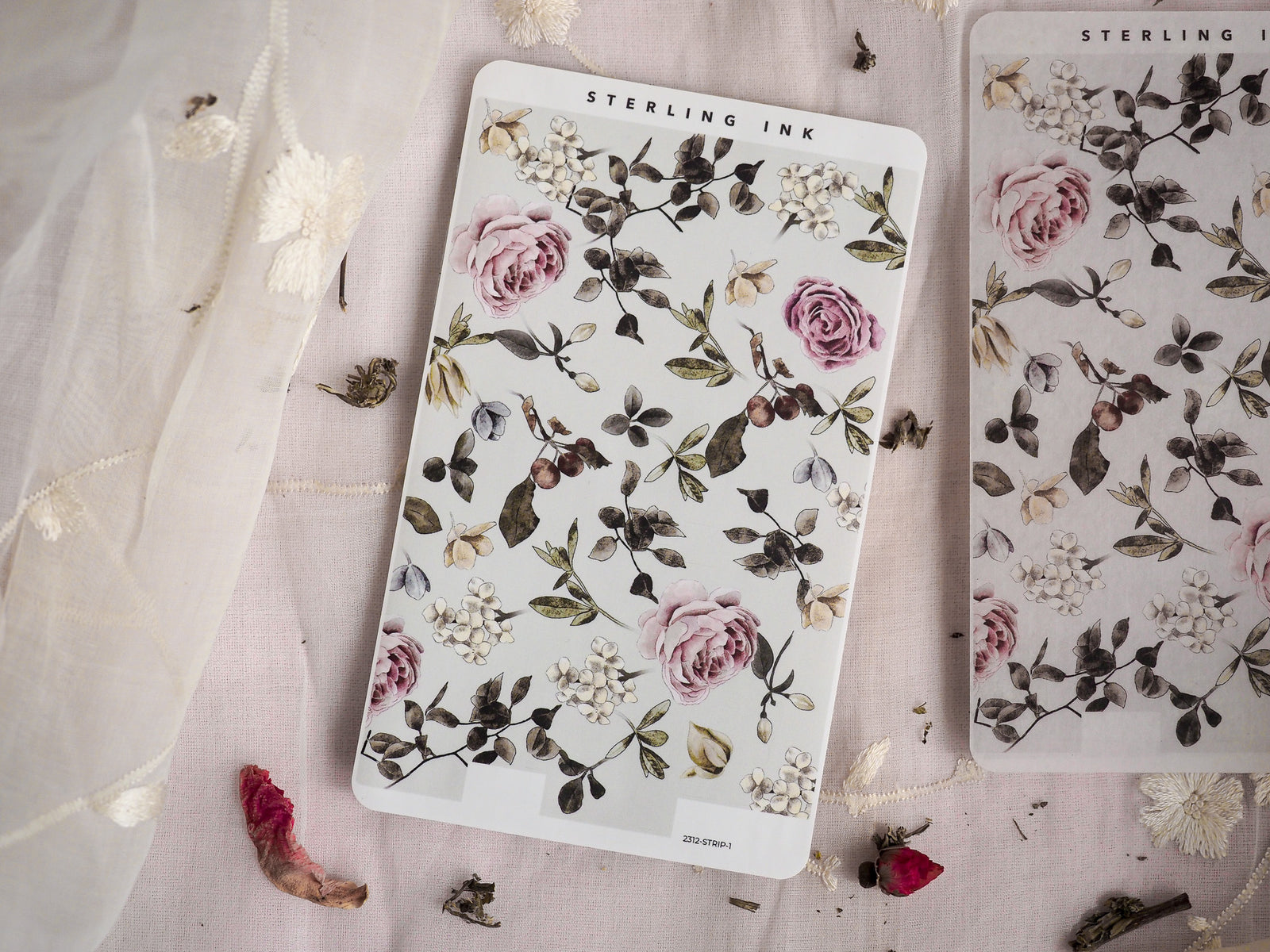 Botanical sticker strips featuring muted pink roses, dark green leaves, and delicate white floral clusters, perfect for December journaling and crafting.
