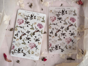 Botanical strip stickers featuring a lush, moody arrangement of dusty pink roses, varied green foliage, and small white filler flowers.