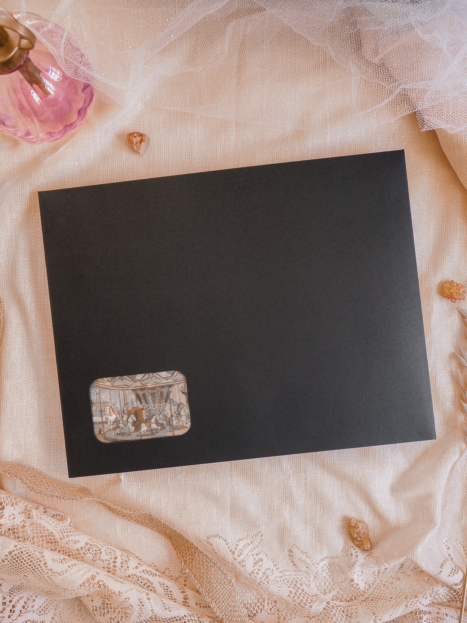 Matte black card featuring a detailed, vintage-style corner vignette illustration, perfect for a limited-edition December 2025 subscription kit.