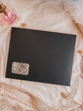 Black subscription kit planner featuring a small, distressed label with sepia-toned, antique script and vintage design elements.