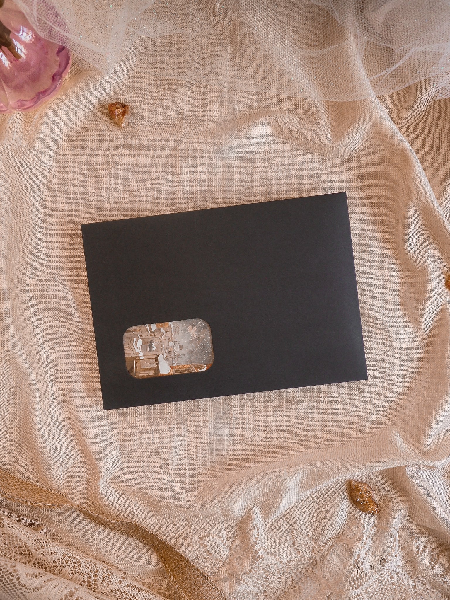 Elegant black card showcasing a natural, translucent crystal window, perfect for December 2025 seasonal crafting and organization.