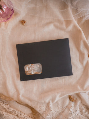 Elegant black card showcasing a natural, translucent crystal window, perfect for December 2025 seasonal crafting and organization.