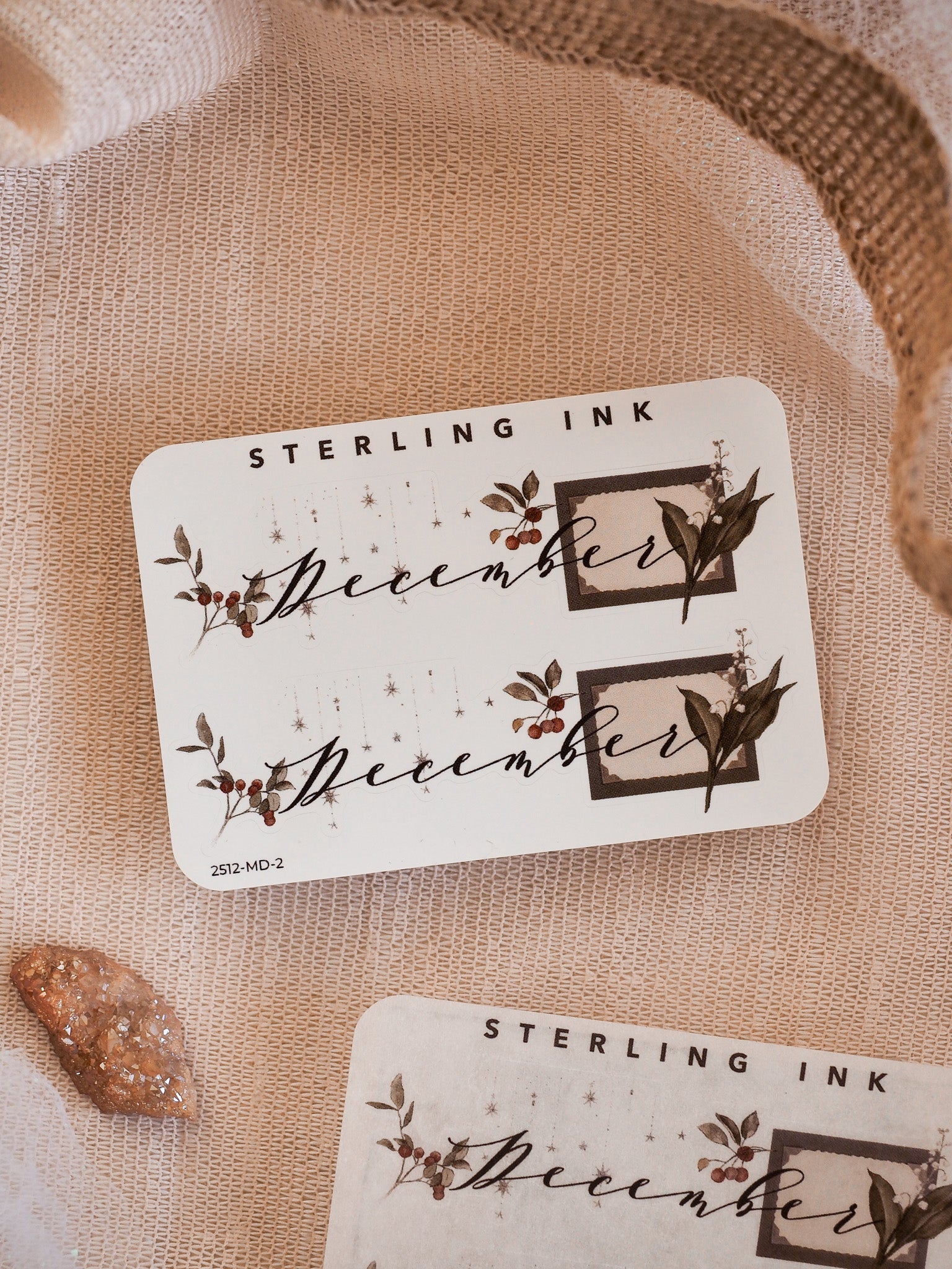 Sepia-toned decorative stickers featuring the month of December, adorned with elegant typography and seasonal leaf corner graphics for journaling or planning.