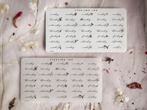 Weekday Stickers - December 2023, featuring elegant black botanical floral and vine motifs printed on delicate white sticker paper.