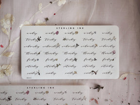 Delicate white weekly calendar stickers for December 2023, featuring hand-drawn botanical accents and labeled days perfect for year-end planning.