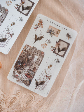 Vintage arrangement stickers for December 2025 featuring intricate botanical motifs, decorative typography, and a detailed, rustic European street market scene.