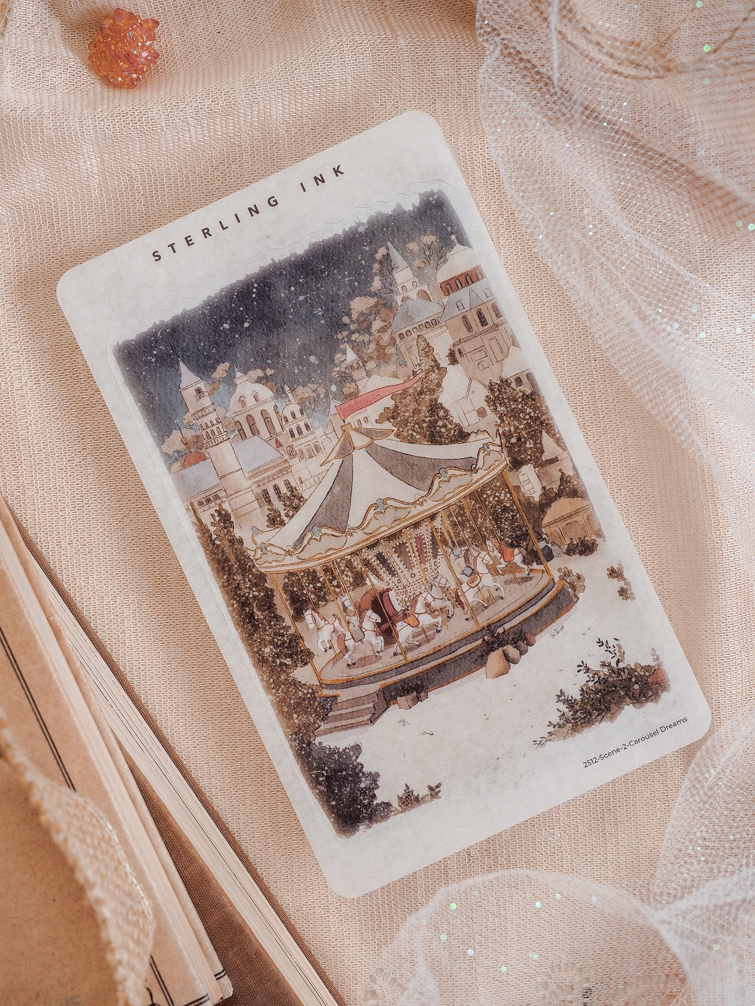 Vintage, sepia-toned sticker featuring a detailed illustration of a festive carousel set against a charming, ornate European town square backdrop.