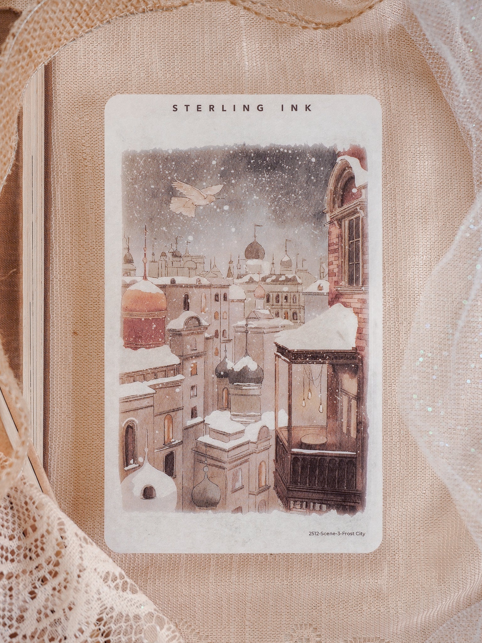 Detailed illustration sticker depicting a charming, snow-covered European city scene, featuring domed rooftops and a classic streetcar, titled "Frost City."