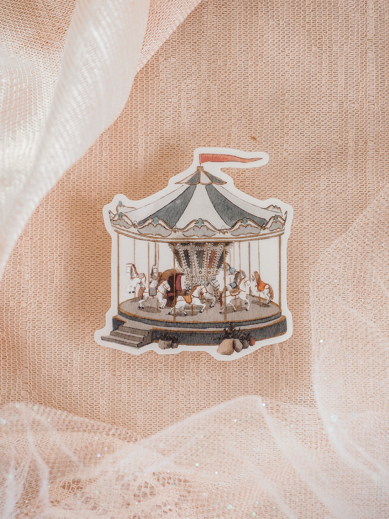 Detailed vinyl sticker depicting a whimsical carousel, featuring multiple horses beneath a classic striped canopy, perfect for celebrating "Carousel Dreams."