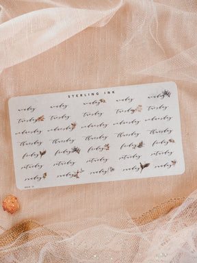 An organized sheet of white planner stickers featuring the theme "Weekday" and decorated with delicate watercolor leaves and floral motifs for journaling.