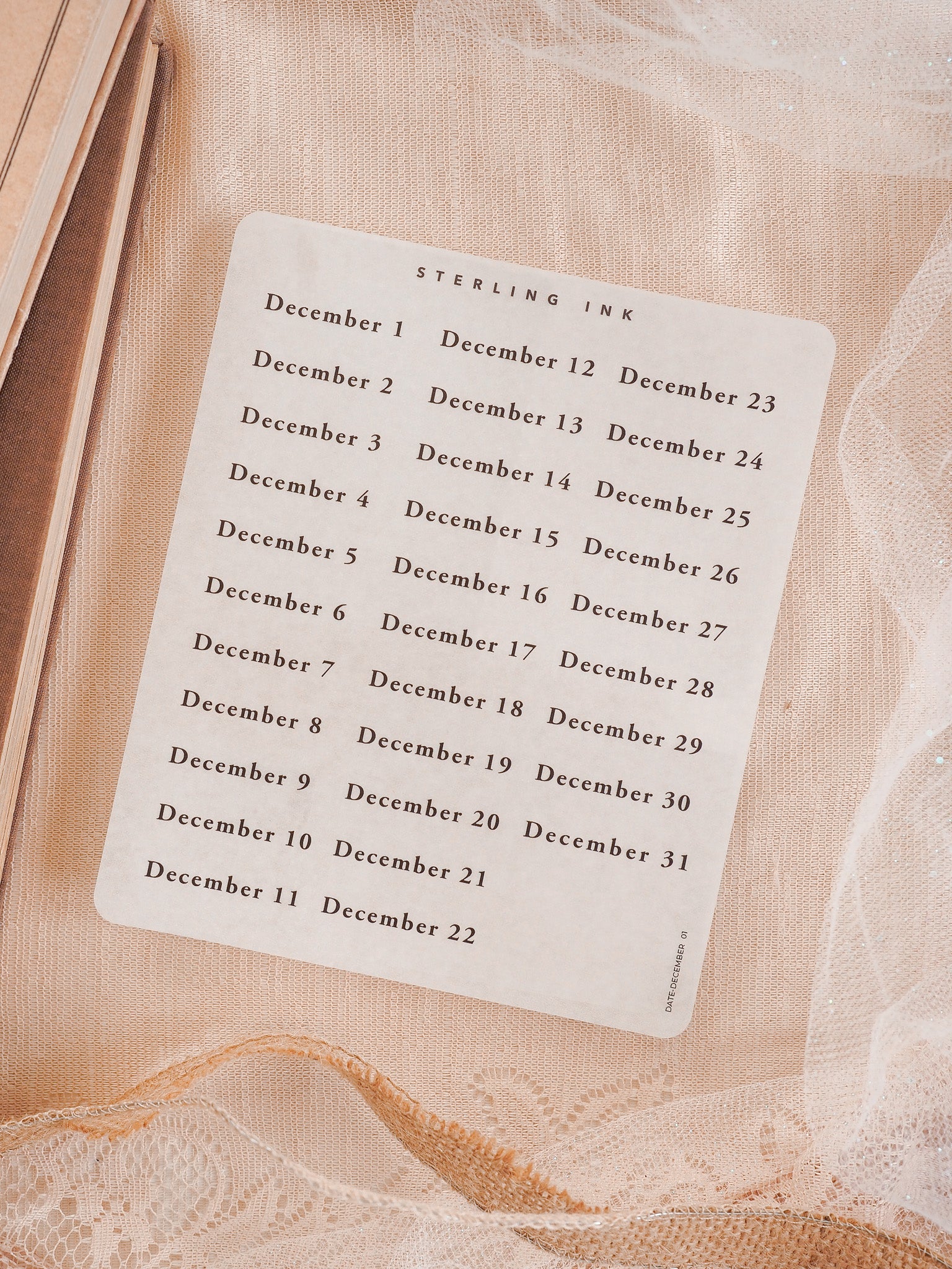 Structured, cream-colored sticker sheet listing the dates for December 2025, printed in black ink for seasonal date tracking and holiday crafting.