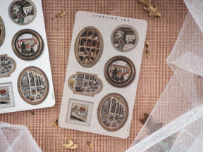 Vintage "Picture Frame Stickers - December 2024" sheets featuring ornate, sepia-toned photo frames filled with classical architectural and holiday cityscape scenes.