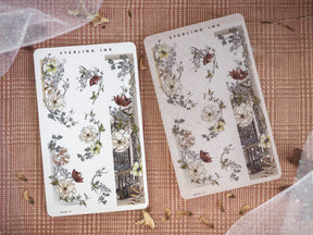 Delicate sticker sheet featuring vintage botanical sketches of roses and lush foliage, accented by dark architectural designs.
