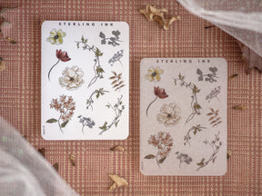 Botanical sticker sheets featuring black and white illustrations of diverse flowers, foliage, and nature elements for craft projects.