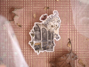 Ornate die-cut sticker featuring an arched architectural facade surrounded by delicate, muted watercolor flowers, perfect for a vintage holiday theme.