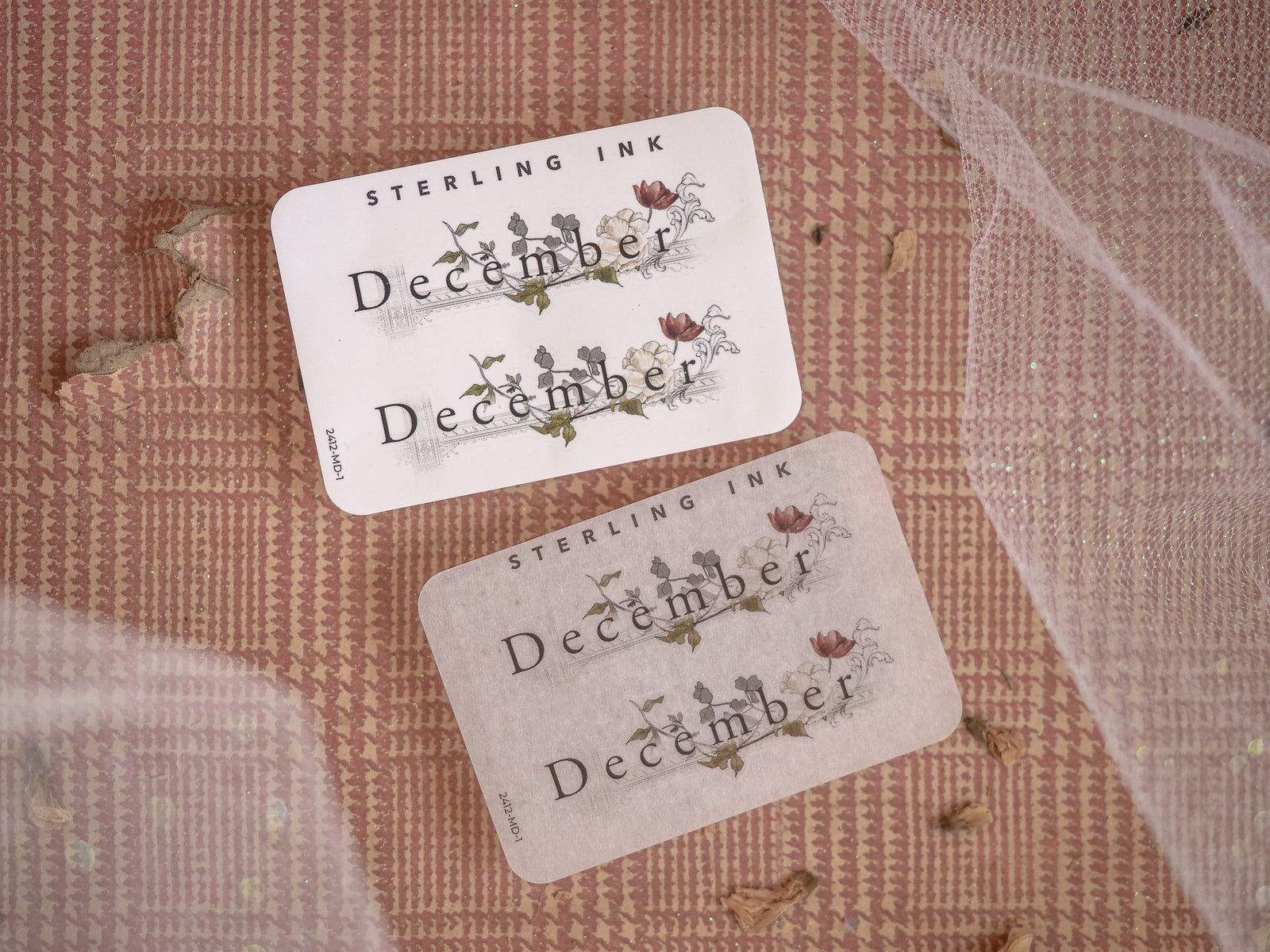 Festive "December" month planner stickers printed on cream paper, featuring rustic and delicate seasonal floral and leaf illustrations.