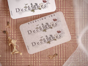 Seasonal December sticker set featuring elegant black lettering and delicate floral motifs printed on kraft cardstock for journaling or planning.
