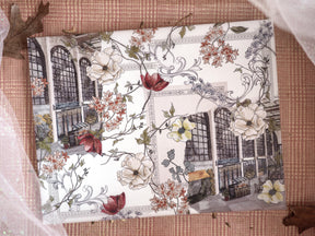 Ornate journal cover featuring a sepia-toned classical facade framed by abundant white, cream, and deep red winter floral vines for December 2024.