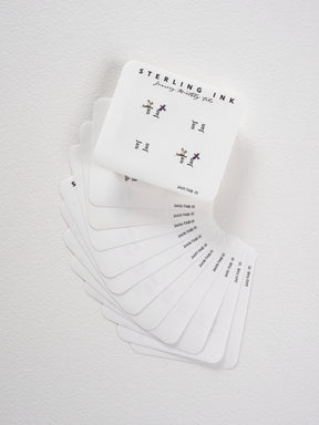 Minimalist set of white monthly tab stickers for 2024, featuring delicate floral accents and organized seasonal planning labels.