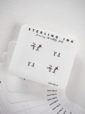 Decorative white planner tab stickers featuring "Sterling Journey Butterfly Ink" branding and delicate golden butterfly and floral illustrations for journaling.