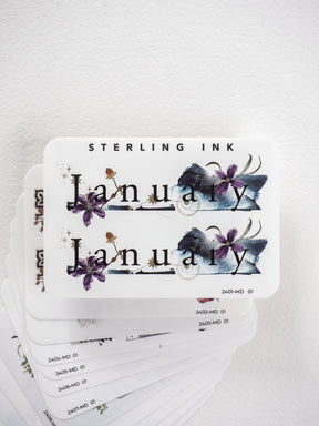 Printable planner stickers showing the word "January" elegantly decorated with rich purple and blue watercolor floral accents suitable for monthly journaling.