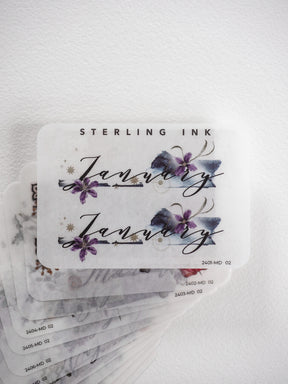 Elegant monthly sticker set featuring watercolor lavender and blue floral designs paired with sophisticated script lettering and gold accents for planners and journals.