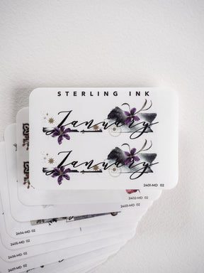 Watercolor floral month stickers for planners, featuring elegant script lettering and delicate purple and gray blossoms.