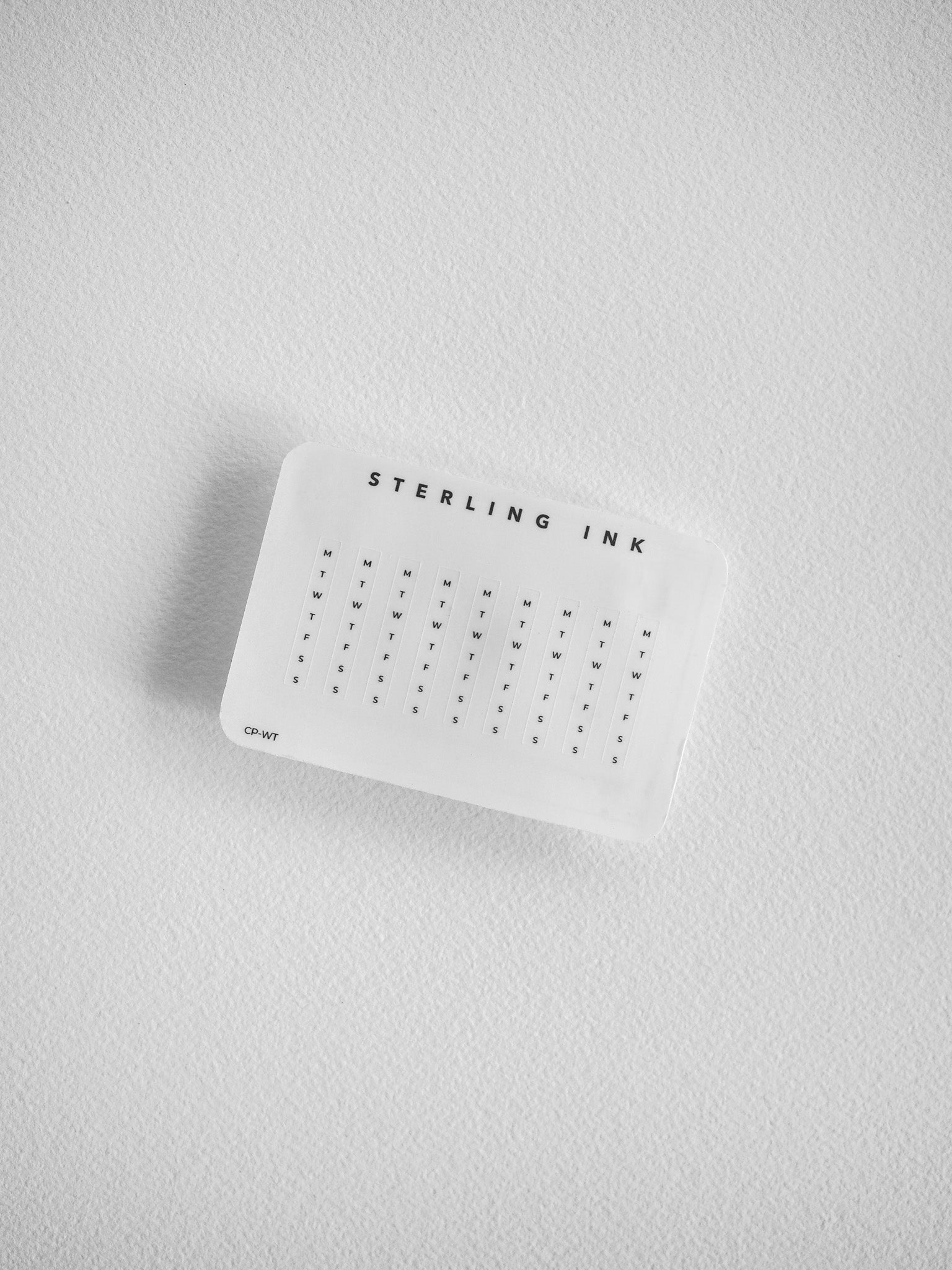 A white, labeled weekly tracker insert from Sterling Ink features a structured grid spanning seven days, designed for organizing weekly schedules and tasks.
