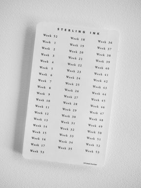 White label sheet containing black text labels for every week, sequentially numbered from Week 1 to Week 53 for annual planning or academic organization.