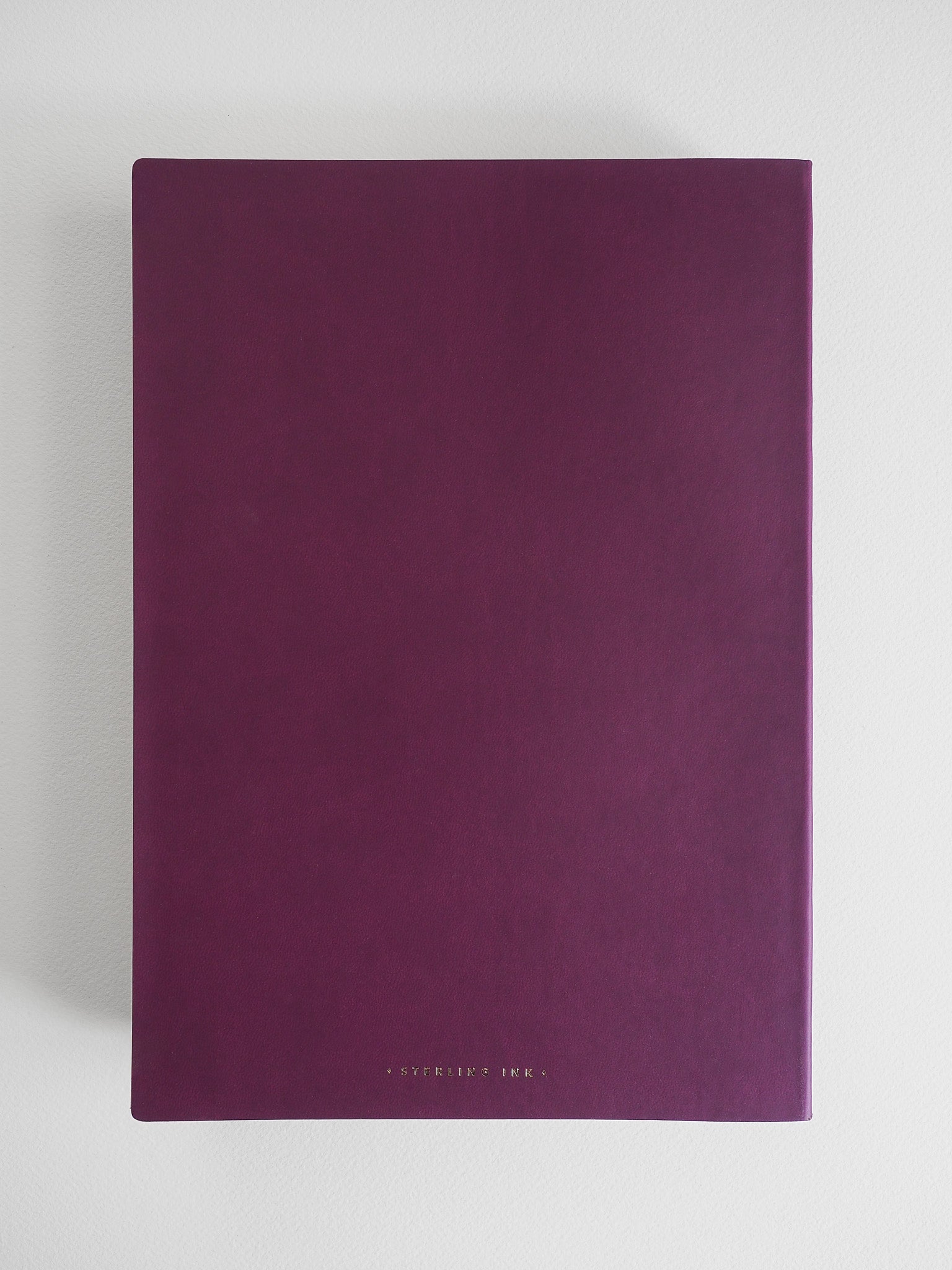 Solid, elegant B5 grid notebook in a deep plum color, featuring minimalist branding on the cover.