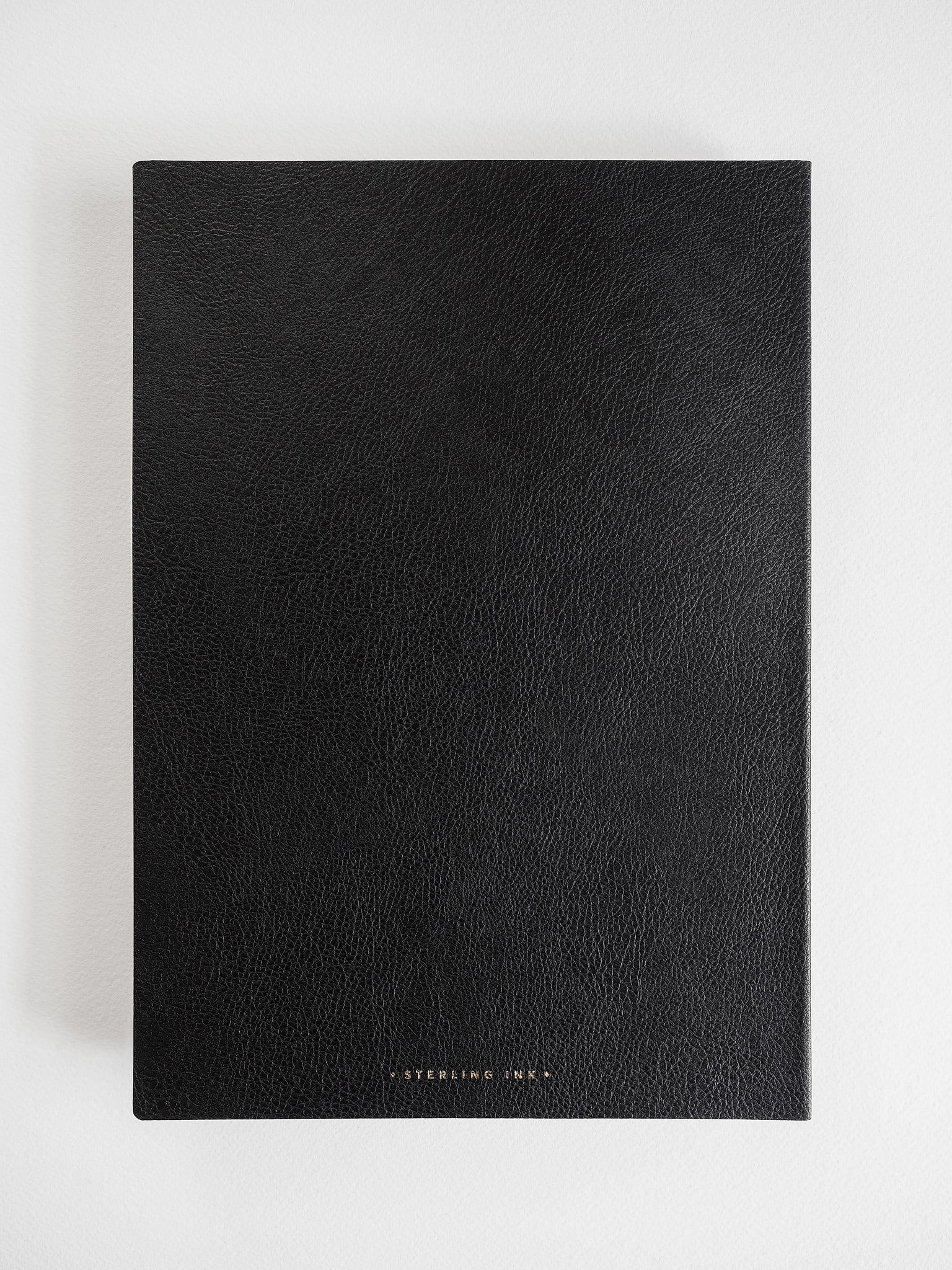 Minimalist black B5 notebook with a sophisticated, textured matte cover and centered "STEARLING INK" branding.